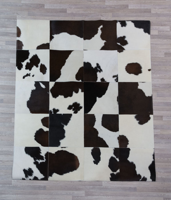 Dark brown and white cowhide patchwork rug
