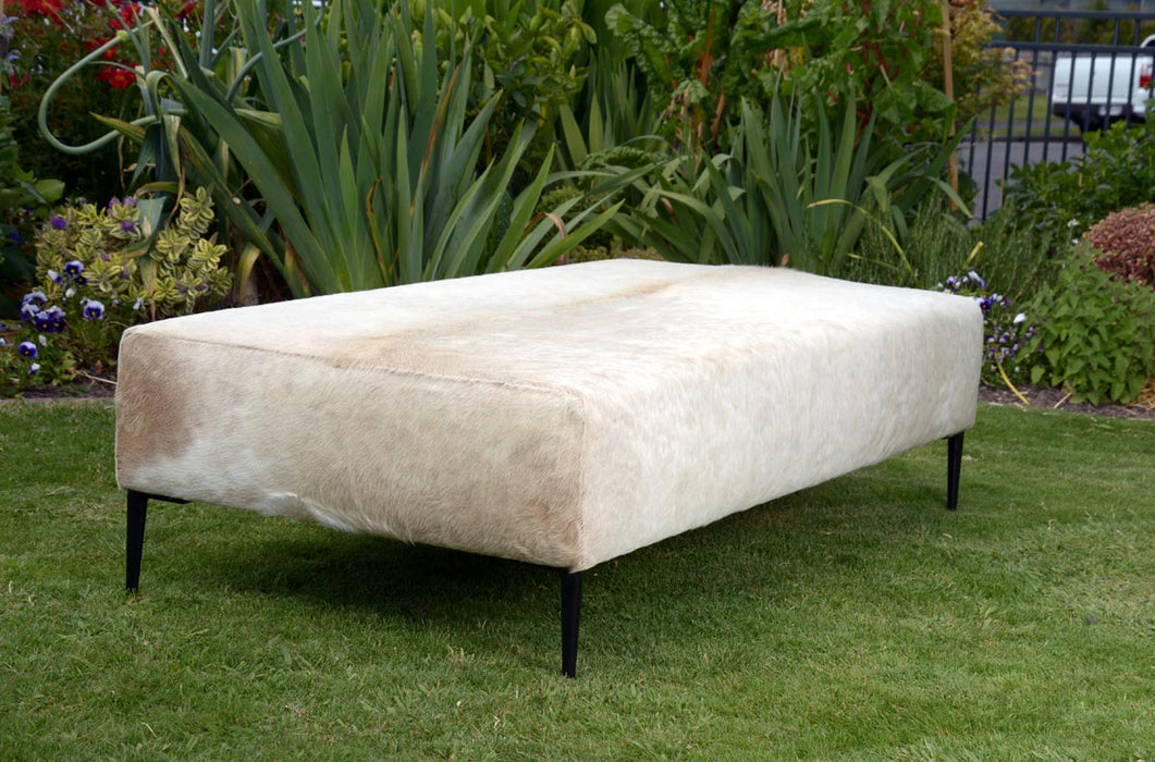 Large cowhide ottoman with black legs