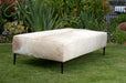 Large cowhide ottoman with black legs