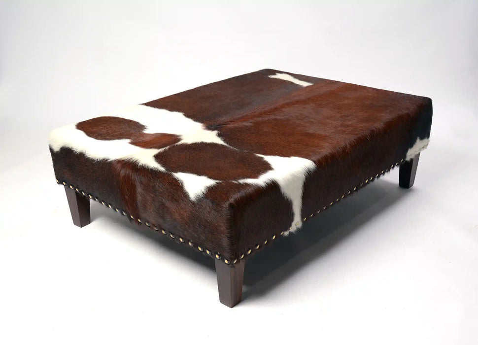 Beautiful cowhide ottoman with studs
