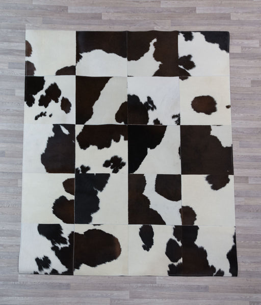 Dark brown and white cowhide patchwork rug